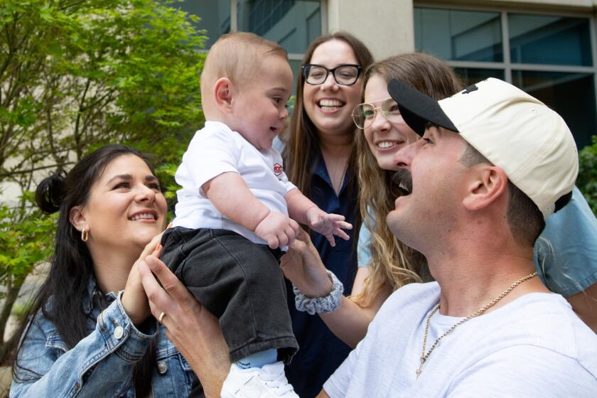 Megan Sanchez, infant Jay Nova Sanchez, Hoag NICU nurses Kylie Collins and Makenna Augusta along with Mikey Sanchez gathered Wednesday for photos at the hospital where the baby was born.