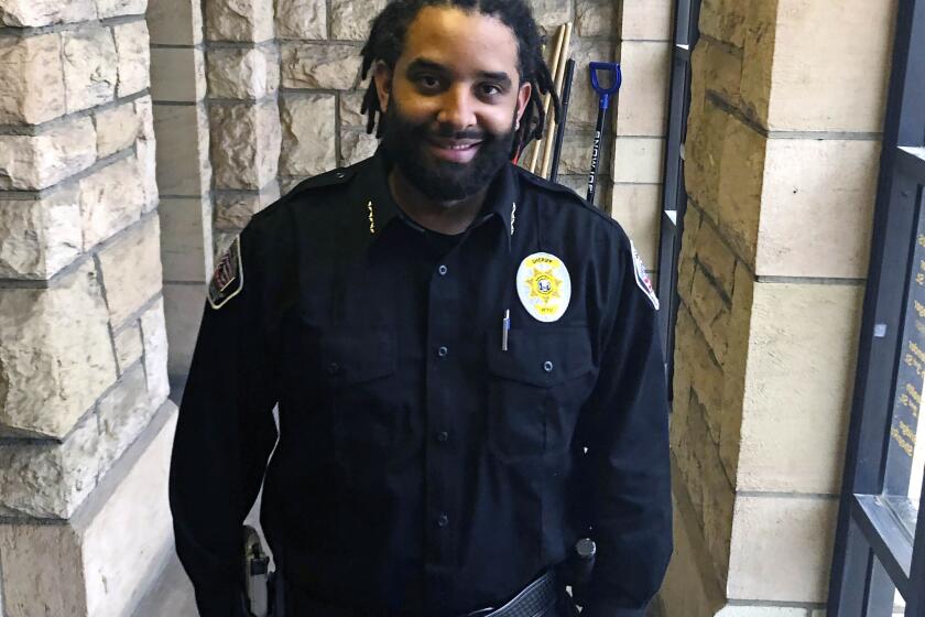 FILE - Albany County Sheriff Aaron Appelhans stands in the county courthouse in Laramie, Wyo., on Feb. 3, 2021. Appelhans is among a rare few in Wyoming, a Democrat, who won in Tuesday's midterm election in this ever-redder state. (AP Photo/Mead Gruver, File)