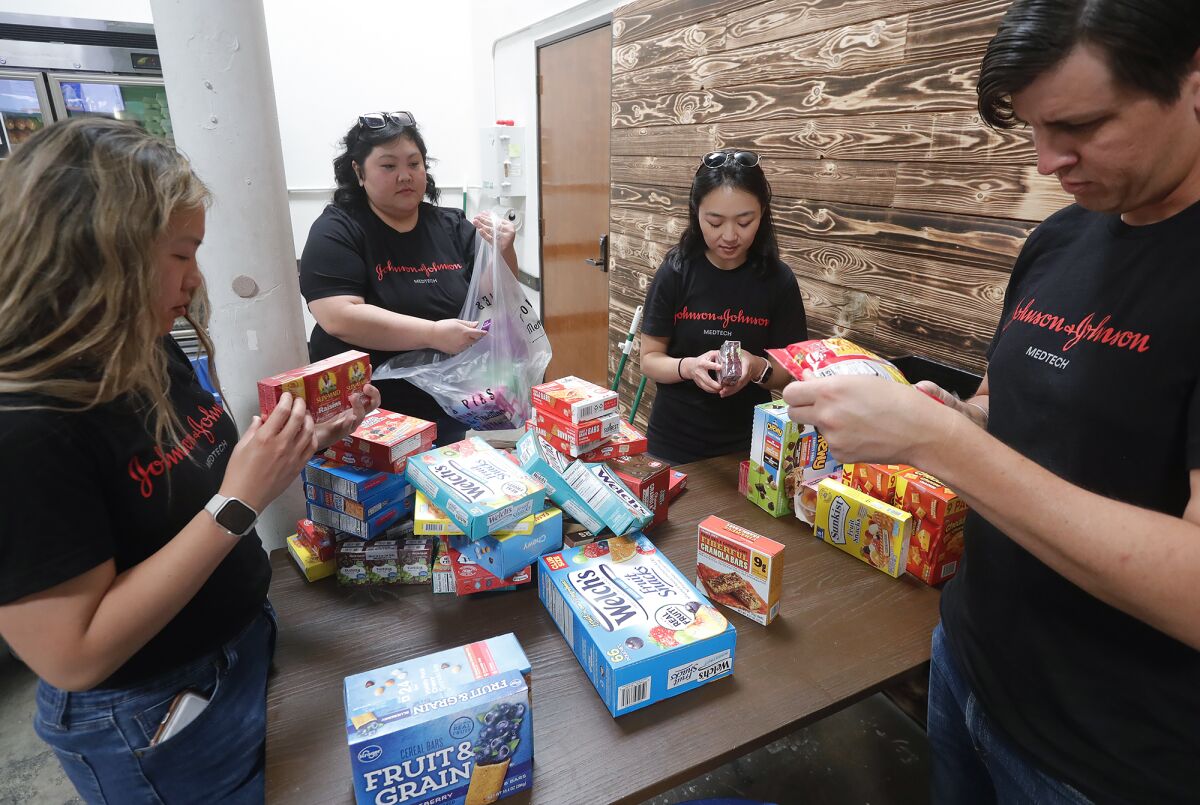 A team from Johnson & Johnson MedTech organizes food items during the Week of Caring.