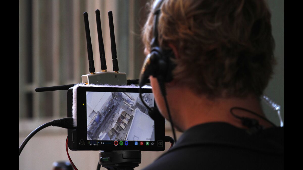 Austin Harris, a camera operator for Aerial MOB, watches a monitor during shooting of a scene for "Criminal Minds: Beyond Borders" in Santa Clarita.