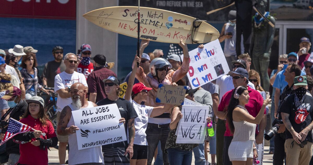 Demonstrators in Huntington Beach protest stay-at-home orders.