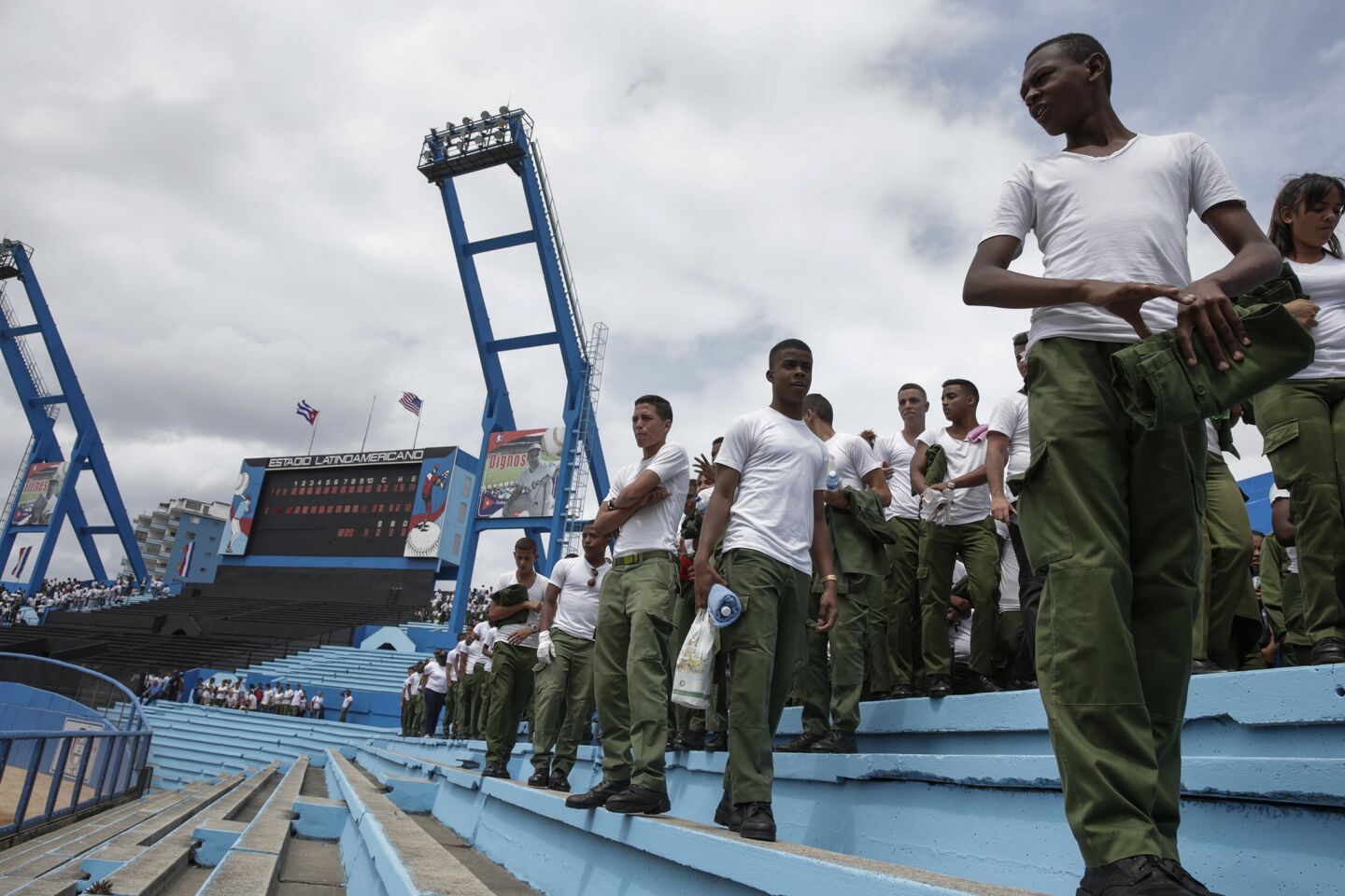 Military school students watch the Cuba National baseball team practice at the Estadio Latinoamericano. The Cuban team will play the Tampa Rays in an exhibition game.