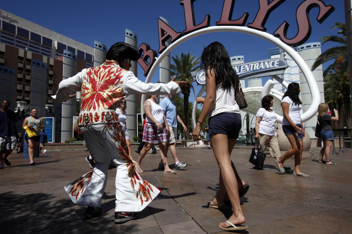 Elvis Presley impersonator Robrigo Gonzalez dances for passing tourists on Las Vegas Boulevard in Las Vegas in 2011. Gonzalez said he became a street performer after losing his job as a welder during the recession.