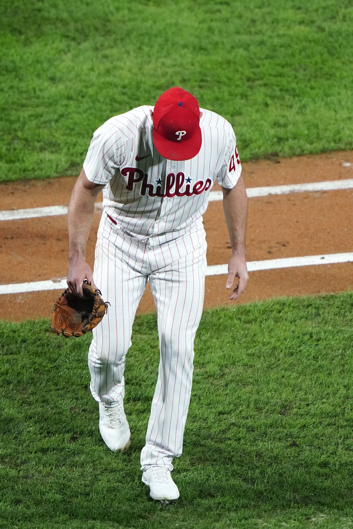 Philadelphia Phillies pitcher Jake Arrieta walks to the dugout after an injury during the sixth inning of a baseball game against the New York Mets, Tuesday, Sept. 15, 2020, in Philadelphia. (AP Photo/Matt Slocum)