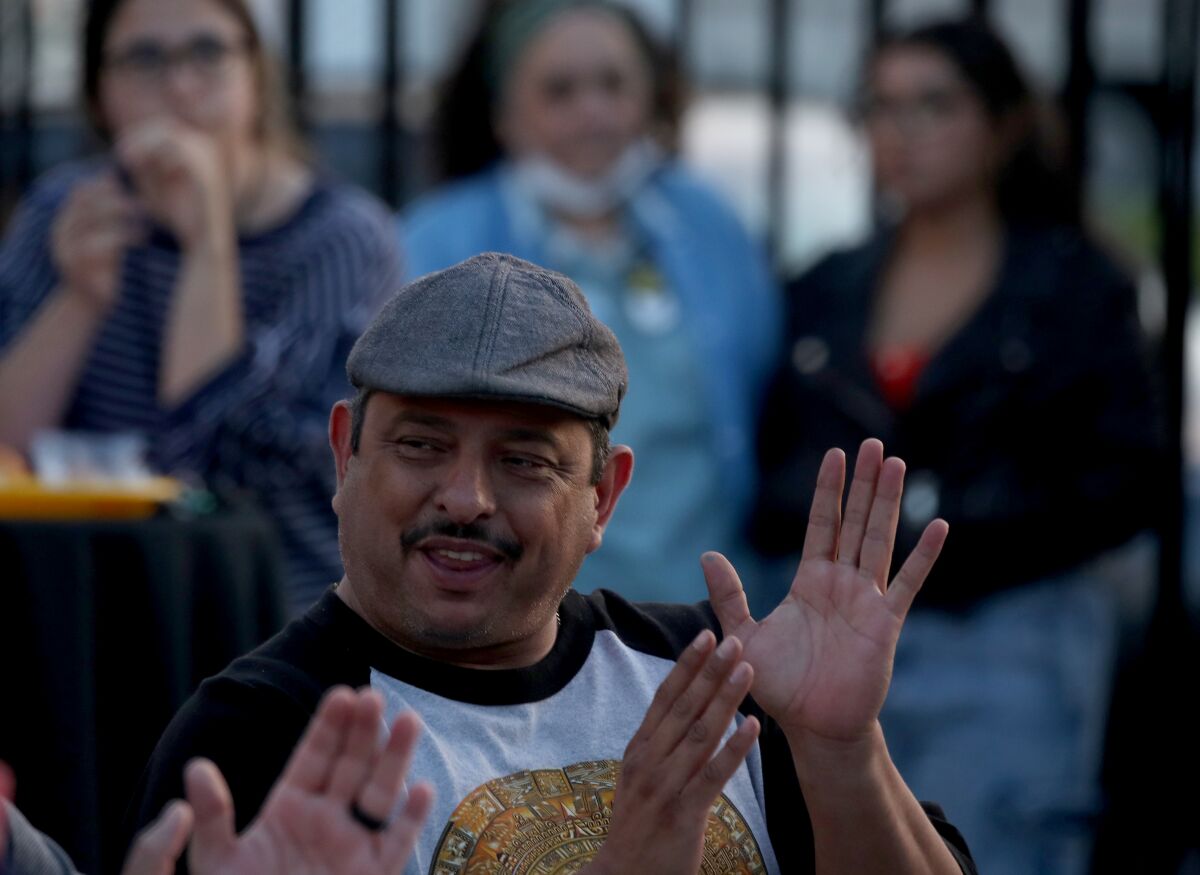 A man in a crowd applauds