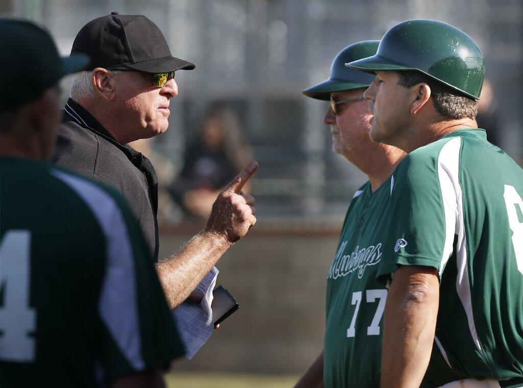 Costa Mesa High Coach Paul Grady, right, is ejected from the game against Estancia on Friday.
