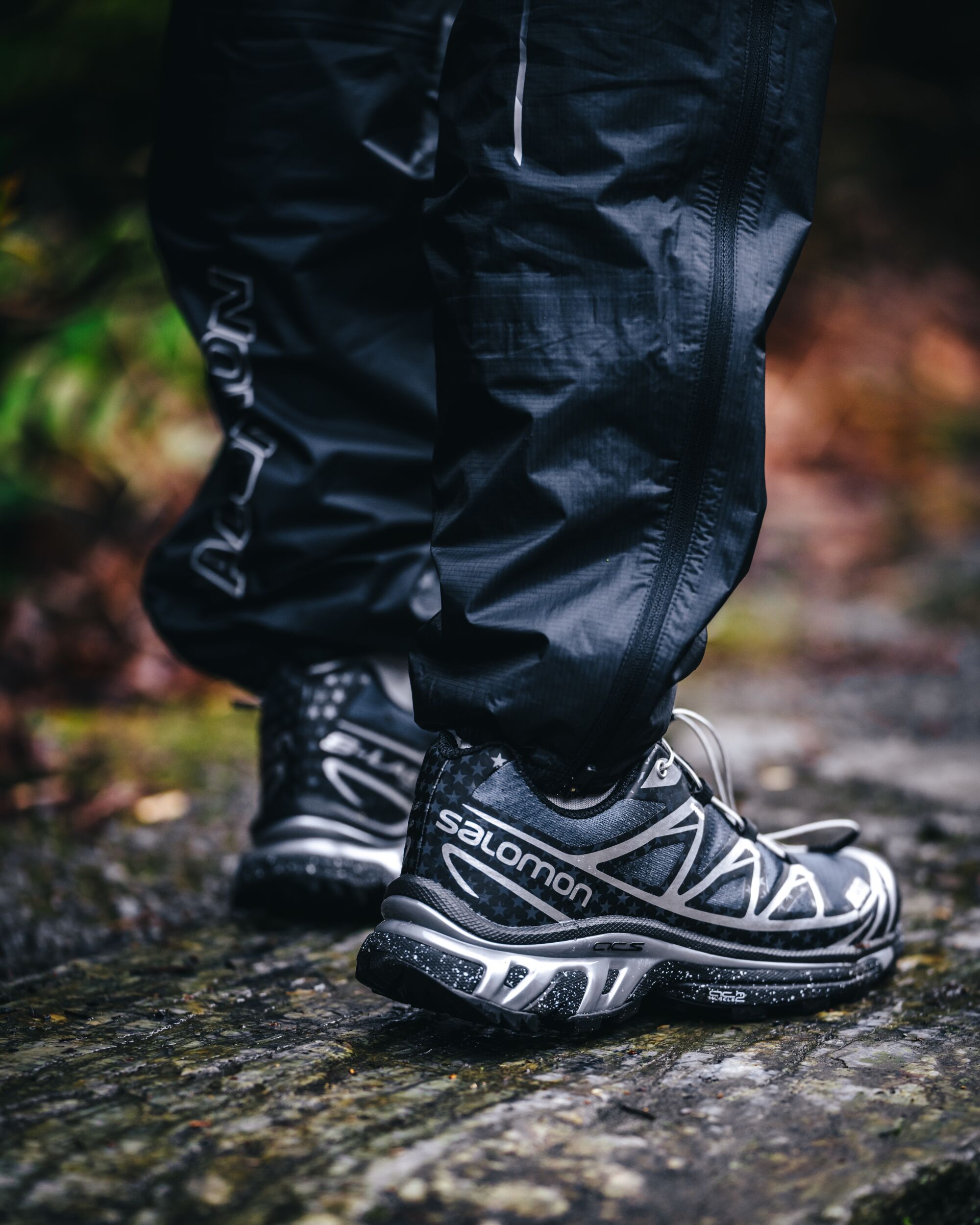 Photo of person in atmos X Salomon sneakers.