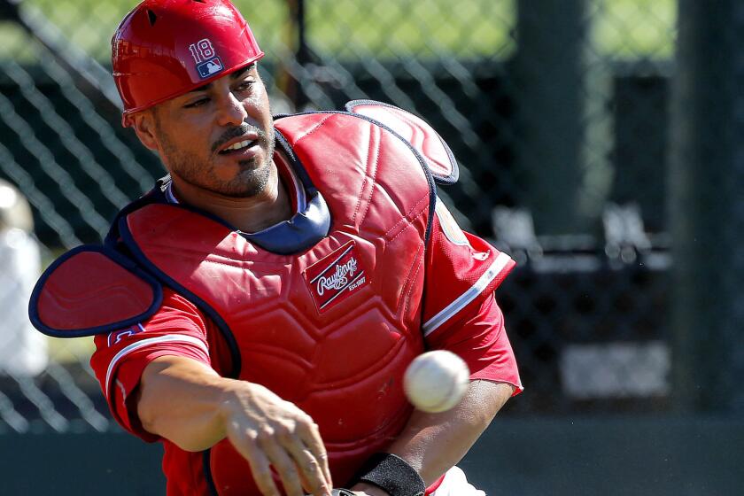 Angels catcher Geovany Soto, who is making a throw to first base during a spring training drill last month, had a three-run home run against the Dodgers on Friday.