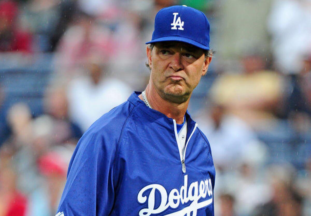 Dodgers Manager Don Mattingly heads back to the dugout after making a pitching change against the Atlanta Braves.