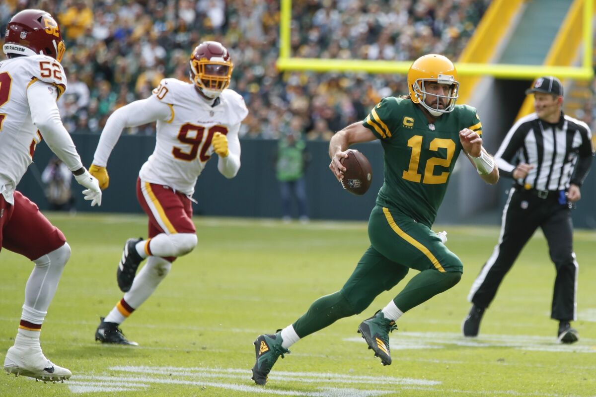 Green Bay Packers quarterback Aaron Rodgers runs with the ball against Washington on Sunday.