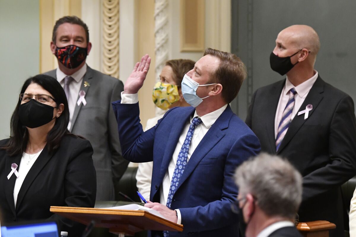 Queensland state Deputy Premier Steven Miles, center, waves to the public gallery after the vote for the Voluntary Assisted Dying bill at Queensland Parliament in Brisbane, Australia, Thursday, Sept. 16, 2021. Voluntary euthanasia became legal in a fifth Australian state more than 20 years after the country repealed the world's first mercy-killing law for the terminally ill. (Darren England/AAP Image via AP)