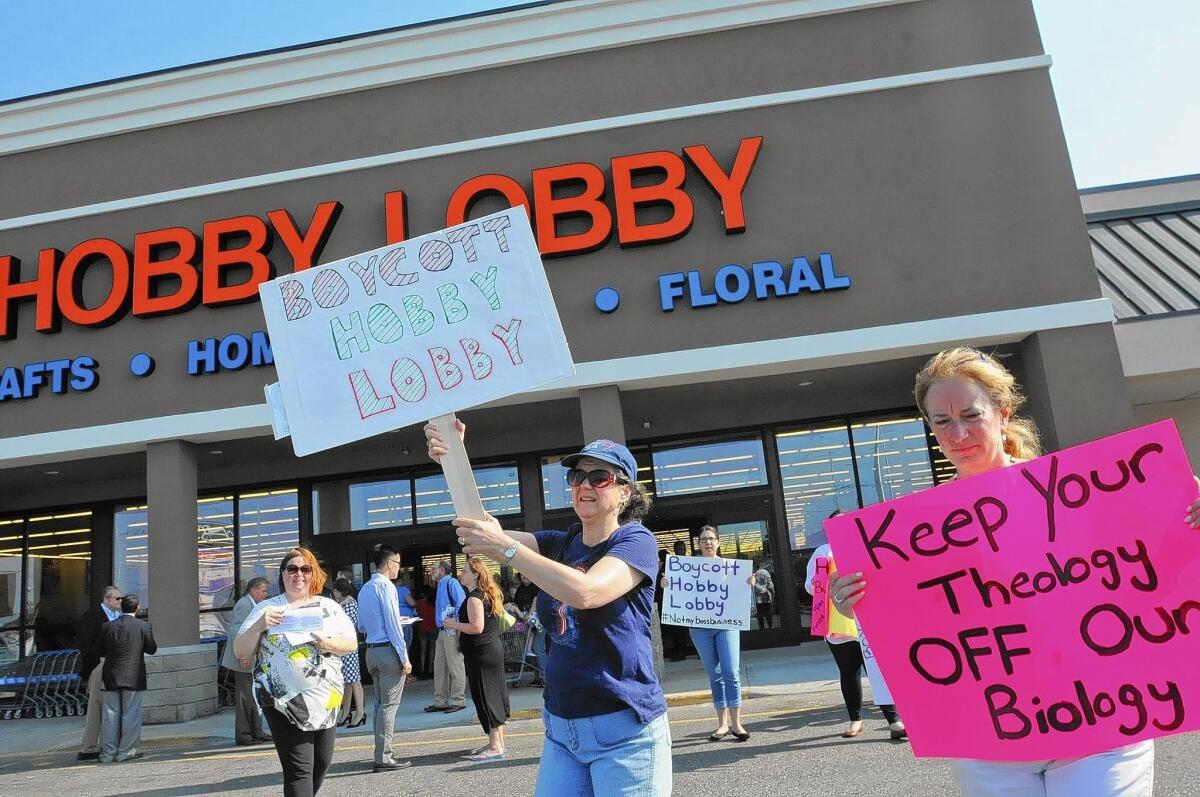 A dozen protesters stand outside the Hobby Lobby in Totowa, N.J., on July 7.