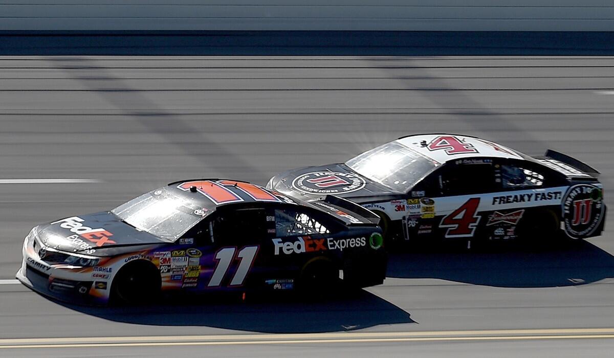 NASCAR driver Denny Hamlin, in the No. 11 FedEx Express Toyota, leads Kevin Harvick, in the No. 4 Jimmy John's Chevrolet, during the NASCAR Sprint Cup Series Aaron's 499 at Talladega Superspeedway on Sunday.