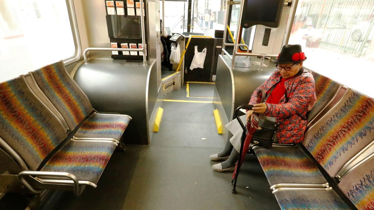 Ridership on Metro's buses and trains has declined 15% over the last five years, with the sharpest drop coming on the agency's buses. Above, a passenger on a bus in 2017.