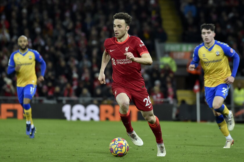 Liverpool's Diogo Jota runs with the ball during the Premier League soccer match between Liverpool and Southampton at Anfield stadium, in Liverpool, England, Saturday, Nov. 27, 2021. (AP Photo/Rui Vieira)