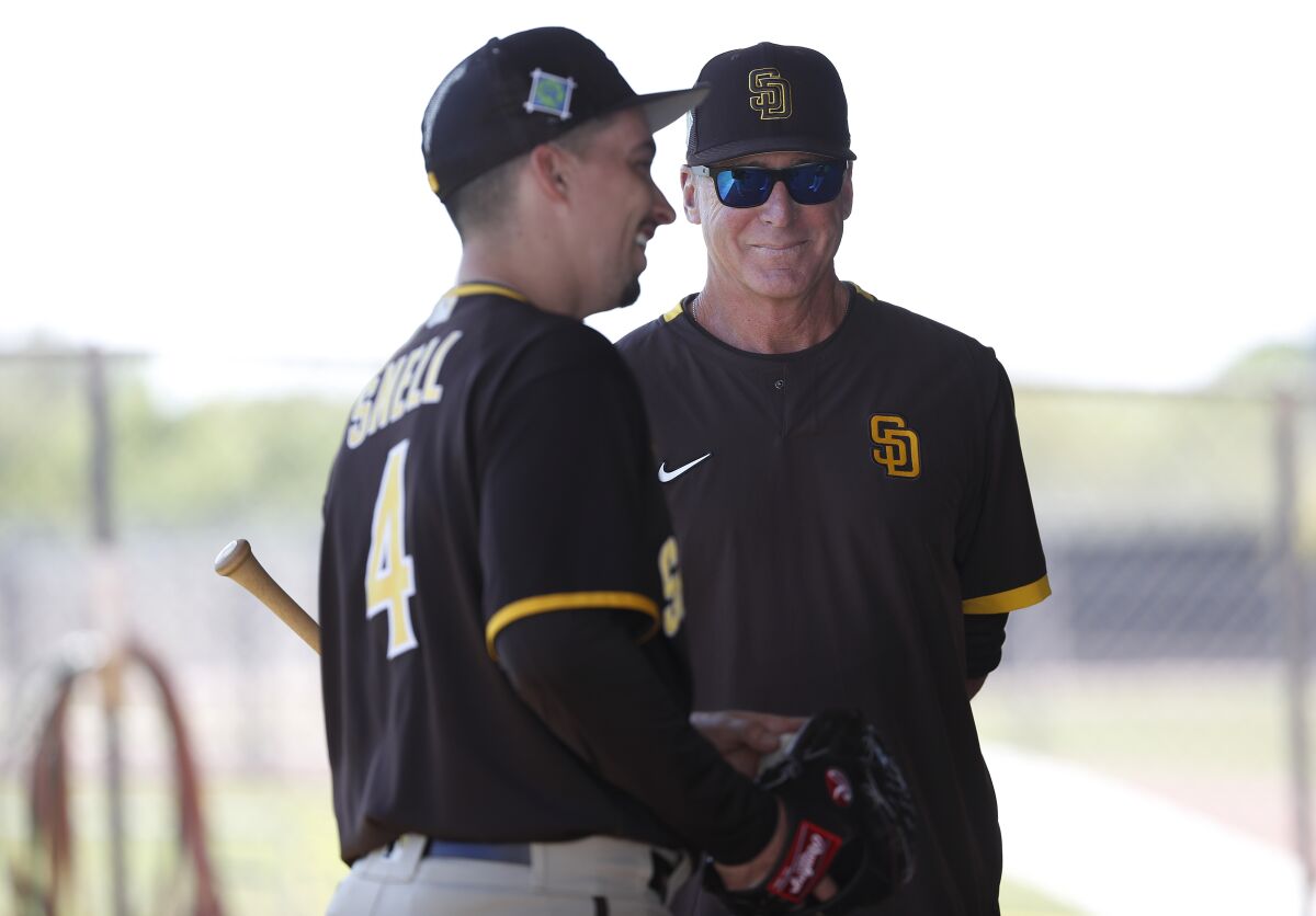 Padres pitcher Blake Snell talks with manager Bob Melvin on March 22 in Peoria, Ariz.