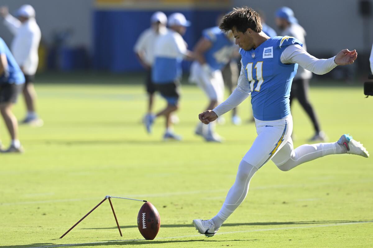 The Chargers' Cameron Dicker practices kicking field goals during camp.