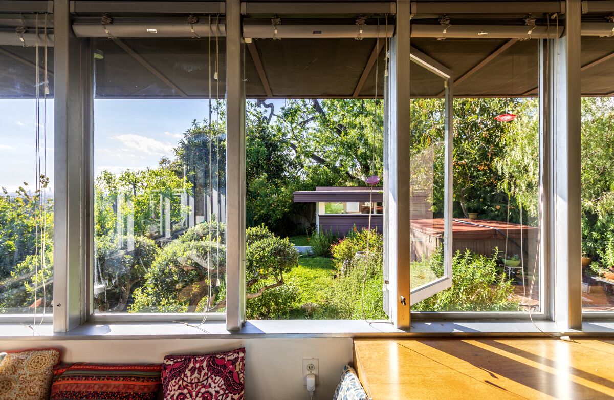 A studio and garden are visible through the windows of a home.