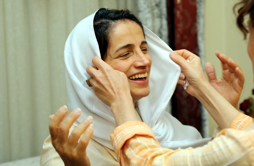 A relative of former imprisoned Iranian lawyer and human rights activist Nasrin Sotoudeh adjusts her scarf at her house in Tehran.