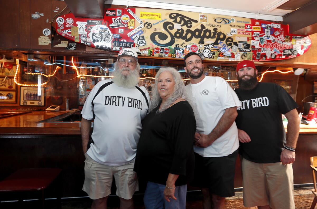 Owners Chuck and Jeannie Harrell, with their sons Spencer and Grant at the Sandpiper Lounge.
