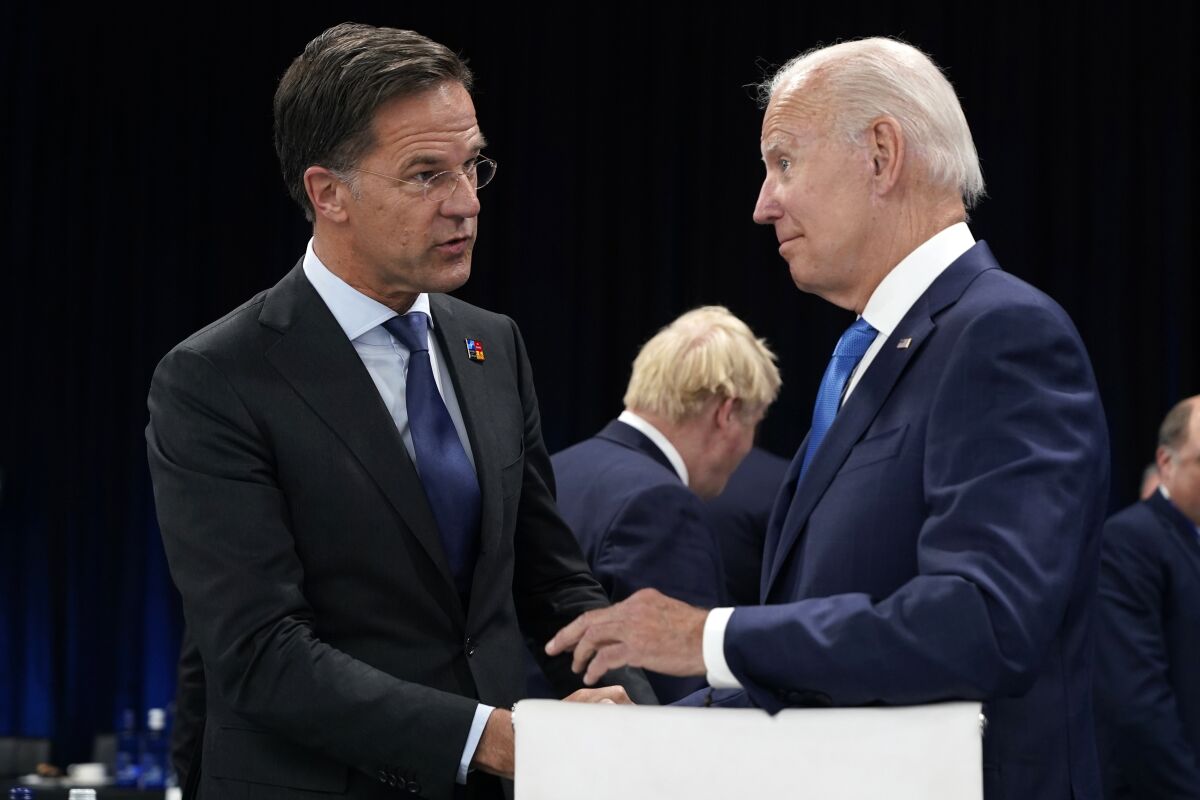 FILE - Netherland's Prime Minister Mark Rutte, left, speaks with U.S. President Joe Biden during a round table meeting at a NATO summit in Madrid, Spain, June 29, 2022. Biden is set to host Dutch Prime Minister Mark Rutte for talks. The U.S. administration is looking to persuade the Netherlands to further limit China's access to advanced semiconductors with export restrictions. (AP Photo/Susan Walsh, Pool)