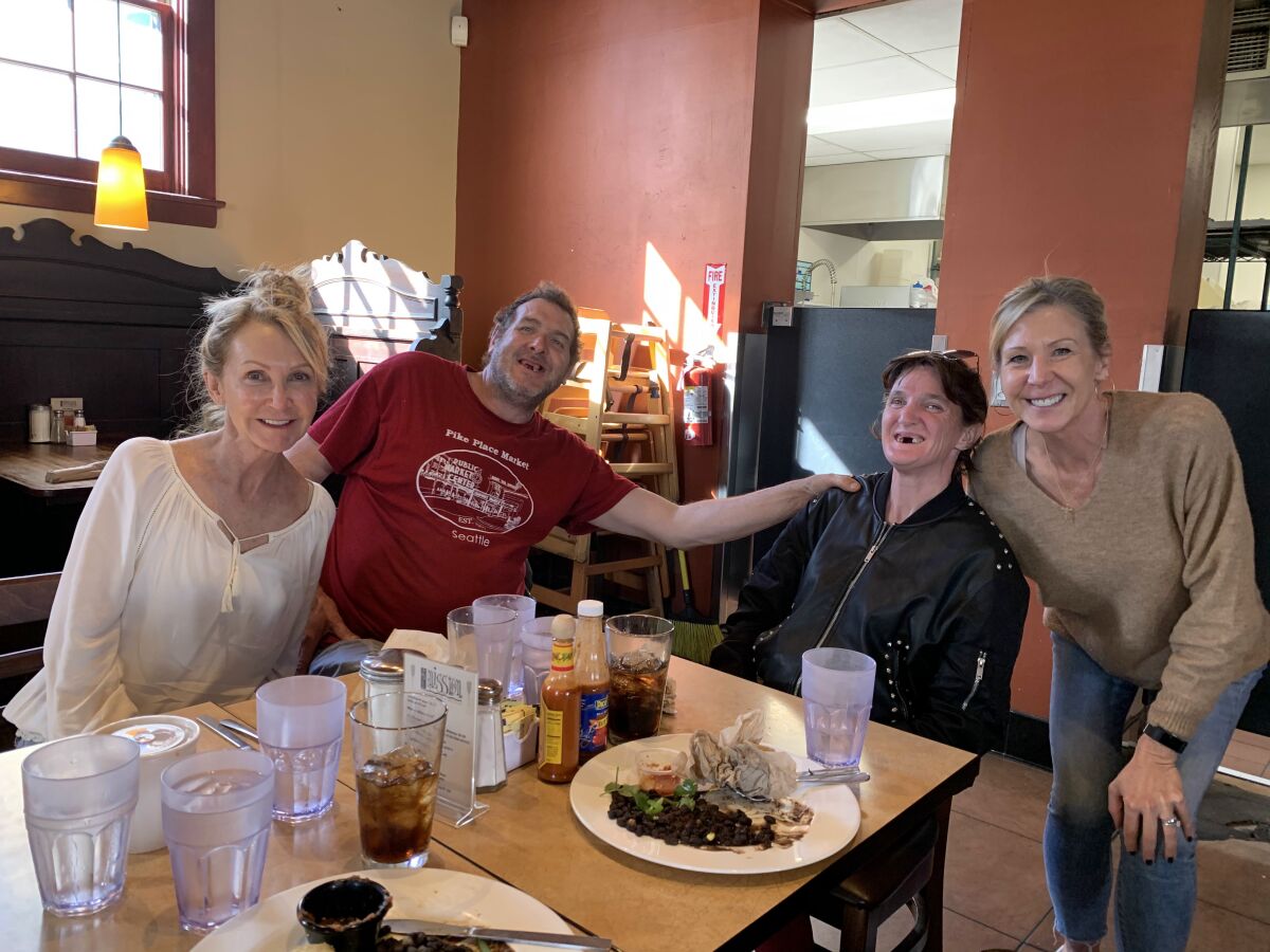 People pose for a picture at a restaurant