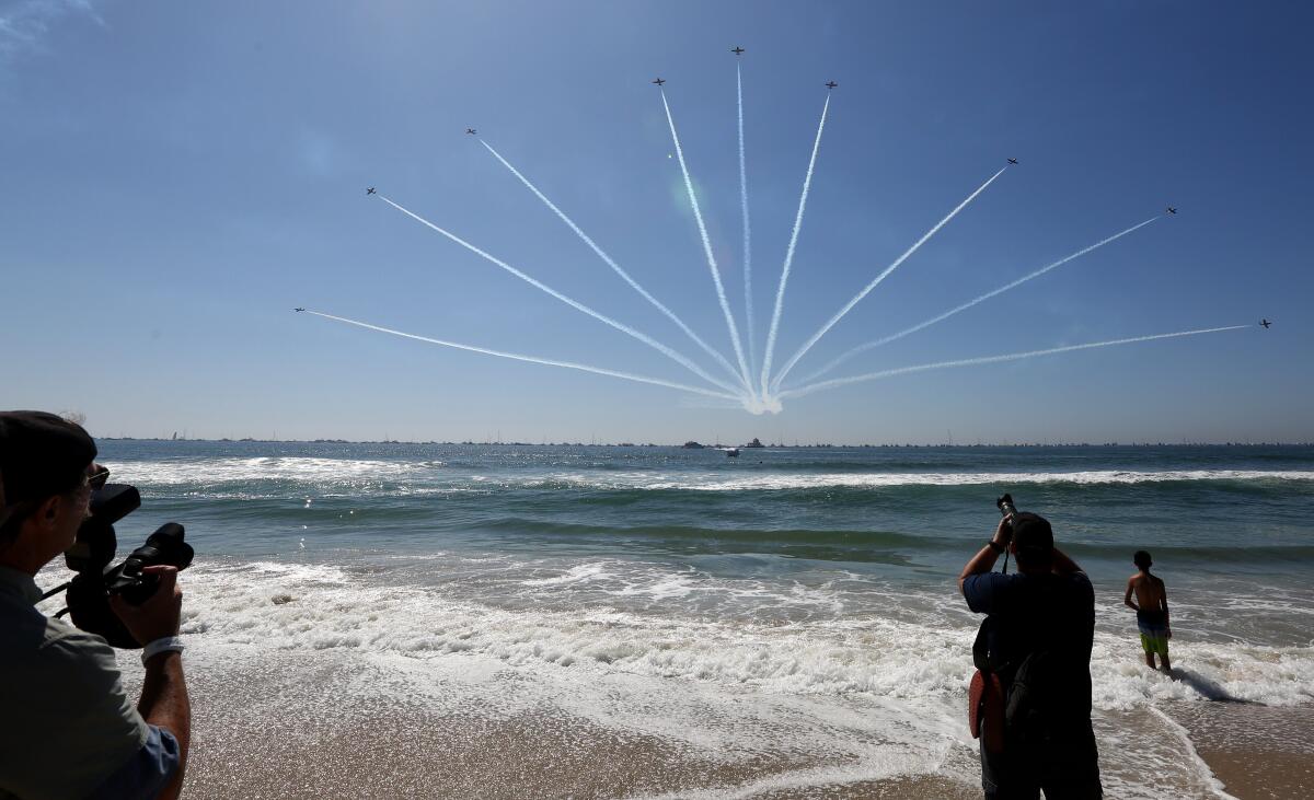 Photographers take aim at the pattern created by the Canadian Forces Snowbirds at the Great Pacific Airshow in 2019.