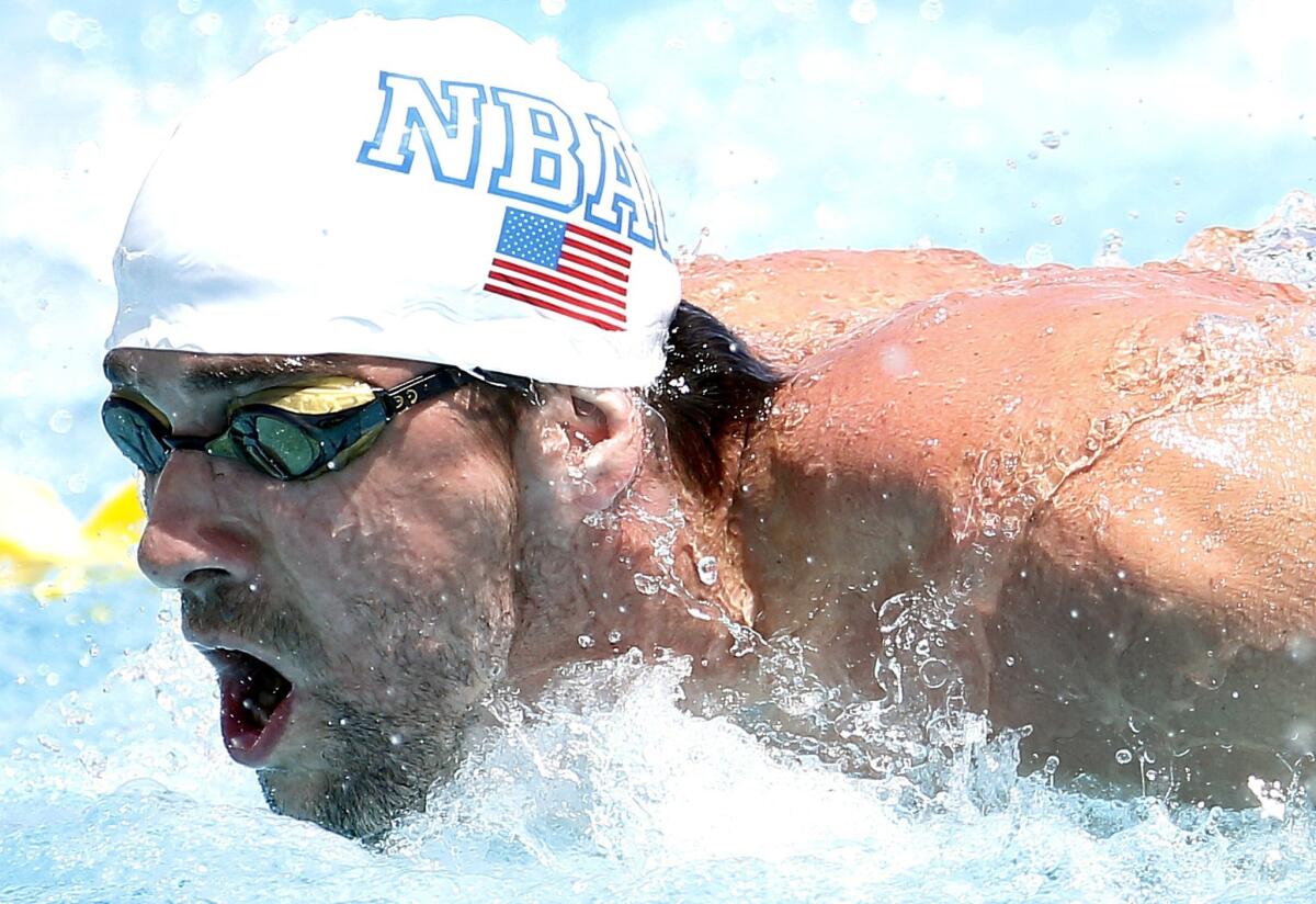 Michael Phelps competes in the 100-meter butterfly event during the Arena Grand Prix on Thursday in Mesa, Ariz.