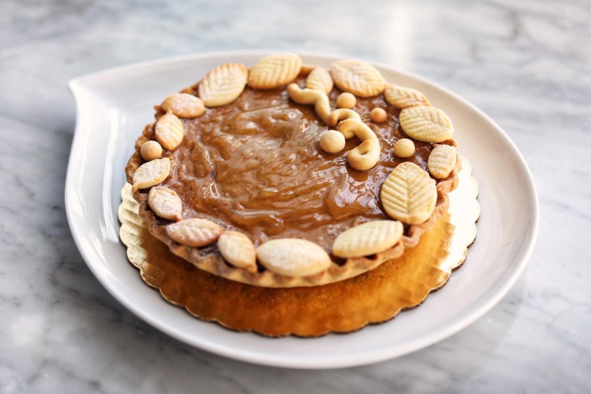 A mini pumpkin pie topped with spiced whipped cream