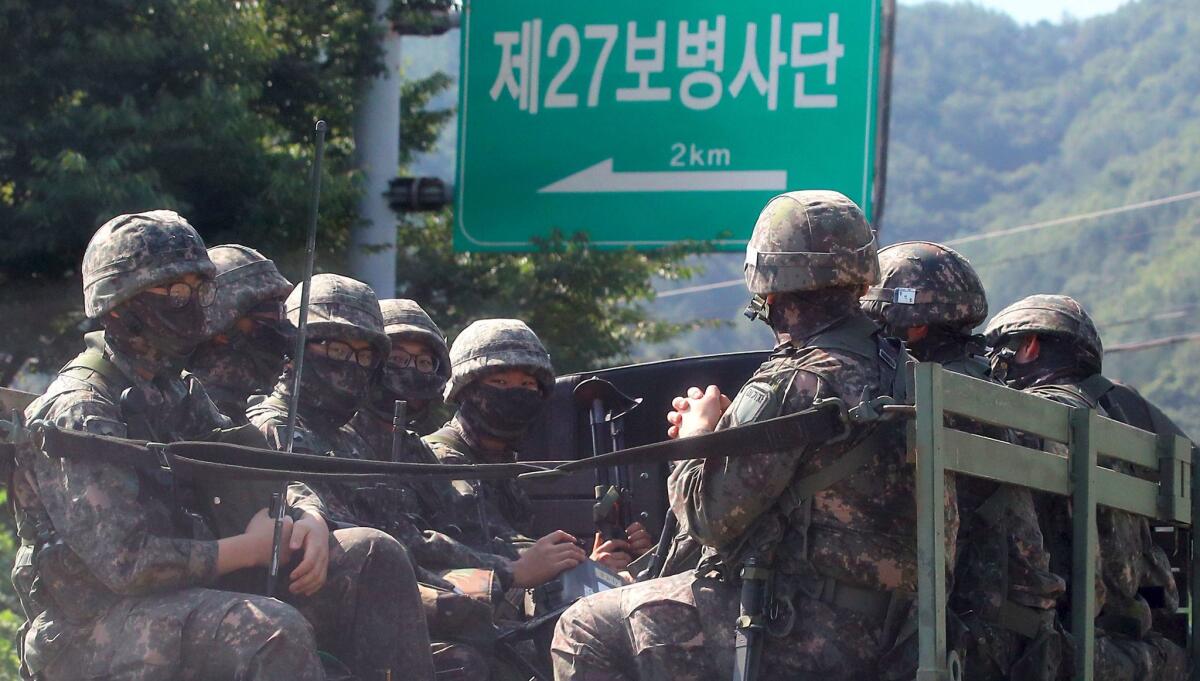 South Korean soldiers ride on a military truck in the border county of Hwacheon on Monday.