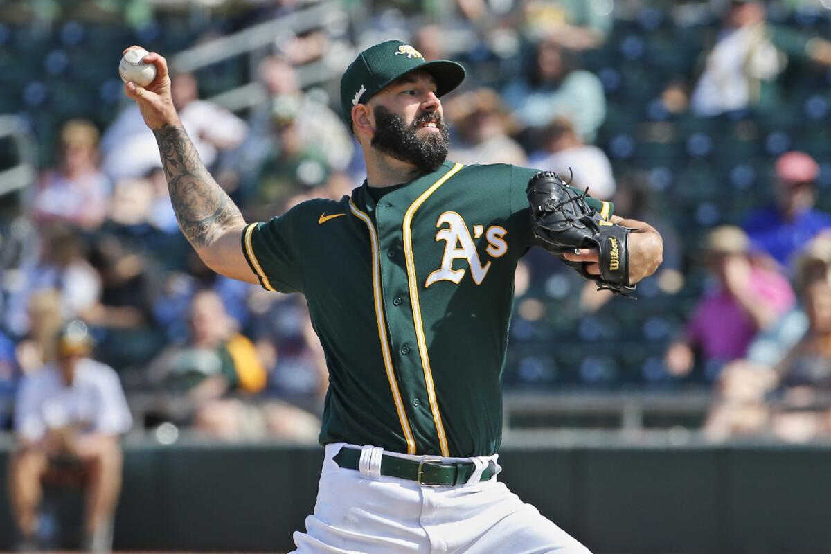 Oakland Athletics pitcher Mike Fiers pitches in the fourth inning of a spring training game against the Dodgers on Thursday in Mesa, Ariz.
