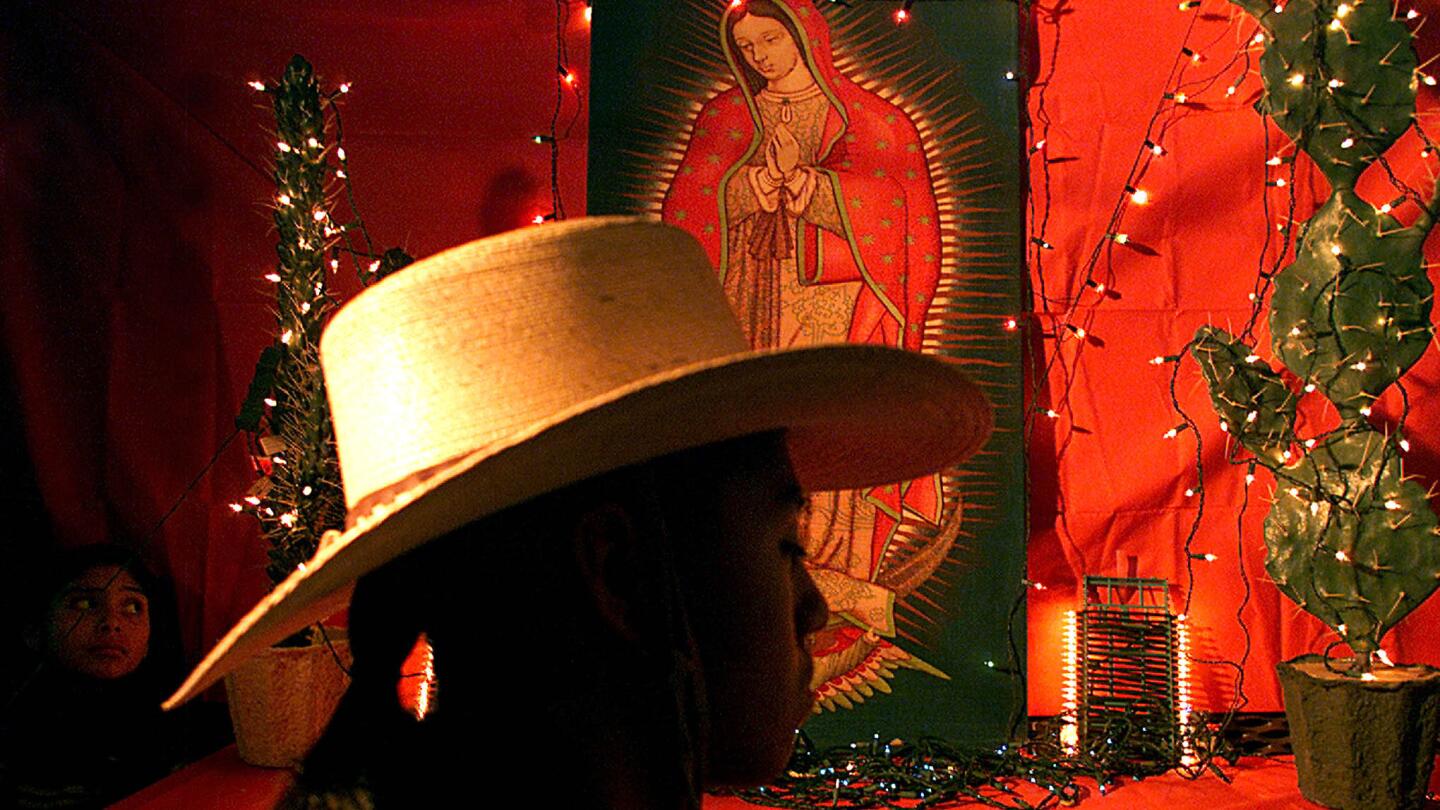 Francisco Varga, 18, prays at makeshift shrine of the Virgin of Guadalupe at Mission Dolores in Boyle Heights, where parishioners gathered for pre-Christmas novenas calling for hope, peace and prosperity in their troubled community.