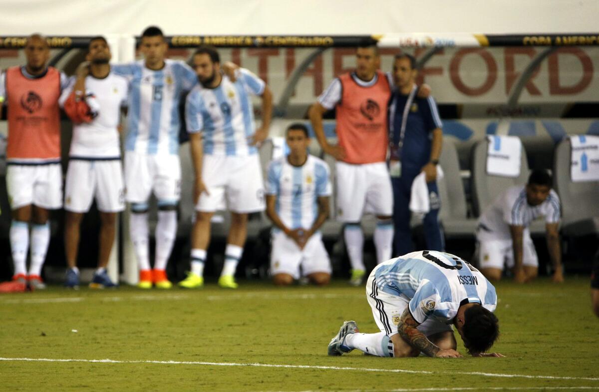 Argentina midfielder Lionel Messi, right, reacts after missing his penalty shot during the Copa America final against Chile.