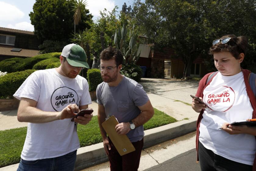 GRANDA HILLS, CA MAY 12, 2019: Jesse Alson-Milkman, 37, left, a paid canvasser, Ian Carr, 28, middle, of Los Angeles, and volunteer Brooke Jacobovitz, (CQ) 25, right, north Hollywood are canvassing door to door in a neighborhood Granada Hills Saturday May 11, 2019. Carr is a Volunteer for Ground Game LA and is stumping for Los Angeles City Council candidate Loraine Lundquist. (Francine Orr/ Los Angeles Times)