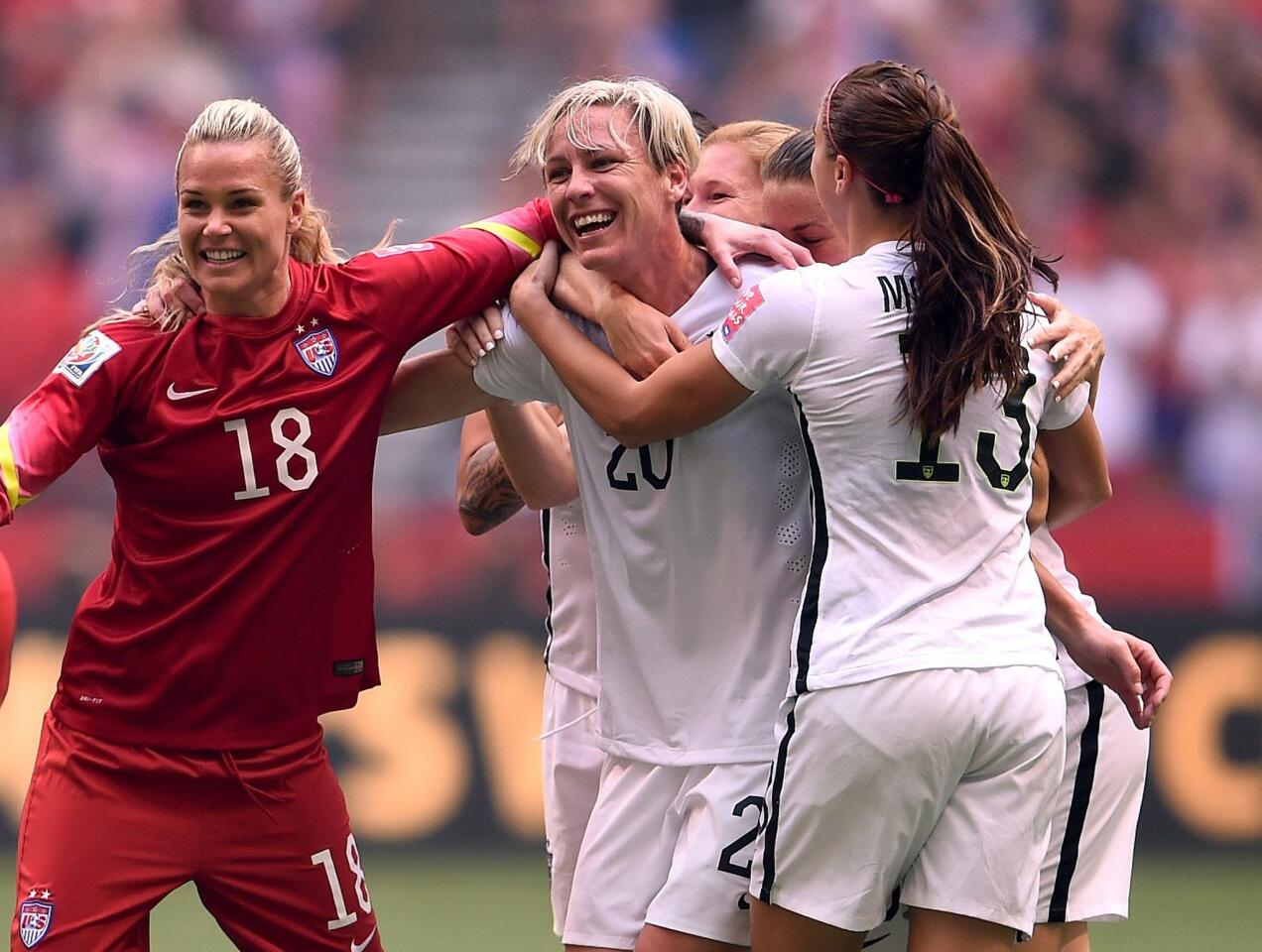 U.S. captain Abby Wambach (20) is surrounded by teammates as they celebrate their 5-2 victory over Japan in the Women's World Cup final on Sunday in Vancouver, Canada.