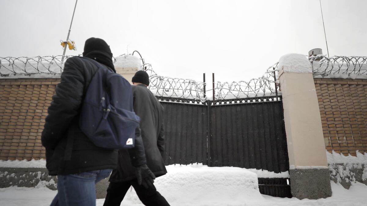 Pedestrians walk outside the Federal Security Service building in Moscow.
