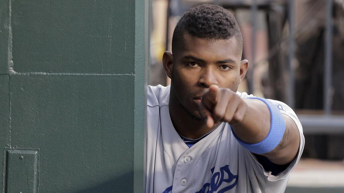 Dodgers right fielder Yasiel Puig points to a teammate in the dugout during Tuesday's game against the New York Mets. Puig continues to build upon his reputation for being a genuine generator of suspense and breathtaking plays.