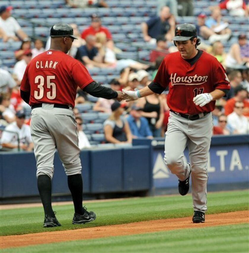 Houston Astros Lance Berkman, right, celebrates with Houston Astros third base coach Dave Clark (35) after hitting a solo home run against the Atlanta Braves during the first inning of a Major League Baseball game Saturday, May 2, 2009, at Turner Field in Atlanta. (AP Photo/Gregory Smith)