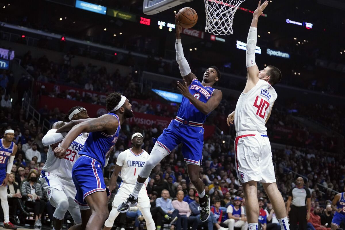 New York Knicks guard RJ Barrett shoots over Ivica Zubac during the first half.