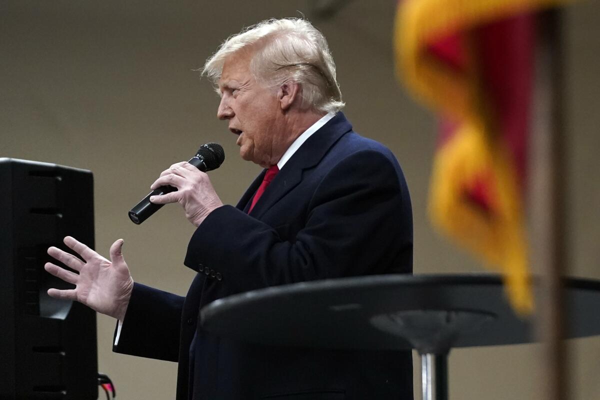 Donald Trump speaks at a caucus site at Horizon Events Center, in Clive, Iowa