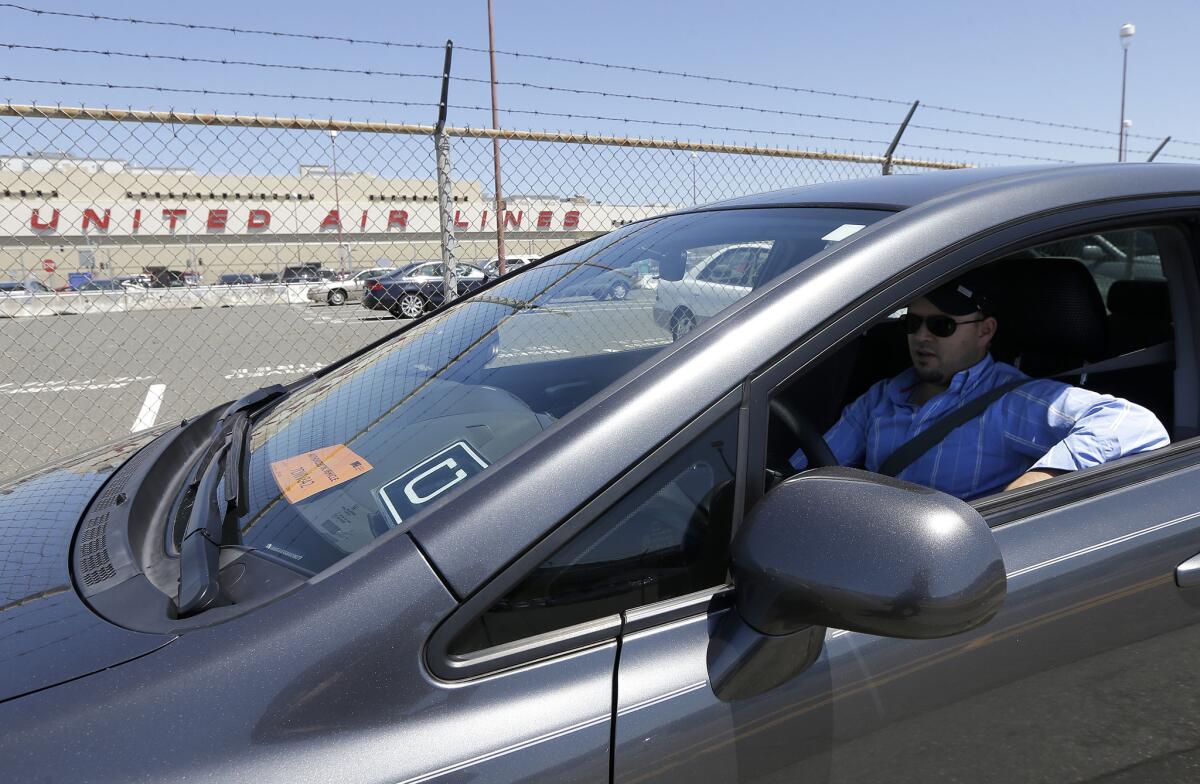 An Uber driver waits for a rider at San Francisco International Airport.