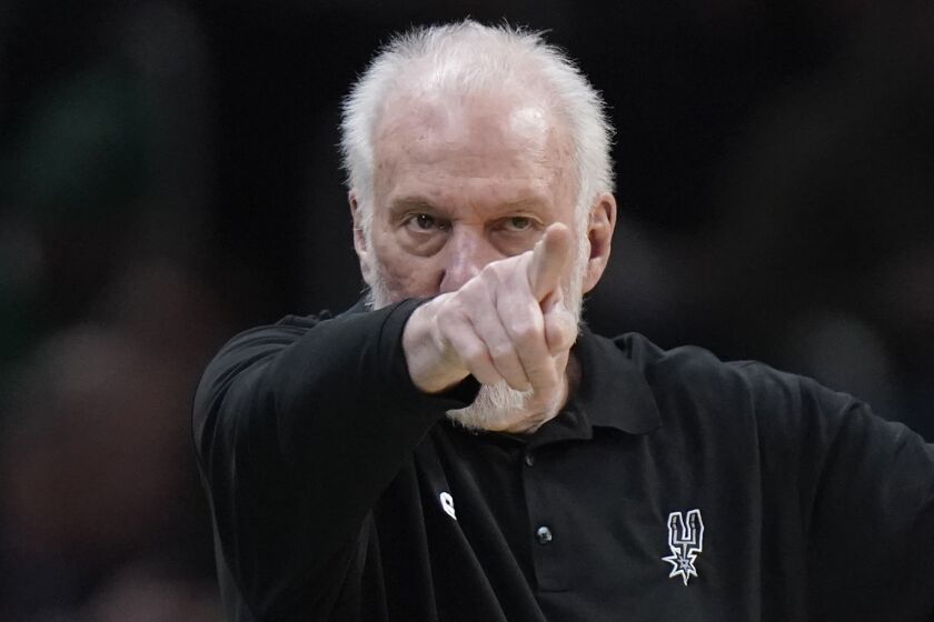 San Antonio Spurs head coach Gregg Popovich points from the bench in the second half of an NBA basketball game against the Boston Celtics, Sunday, March 26, 2023, in Boston. (AP Photo/Steven Senne)