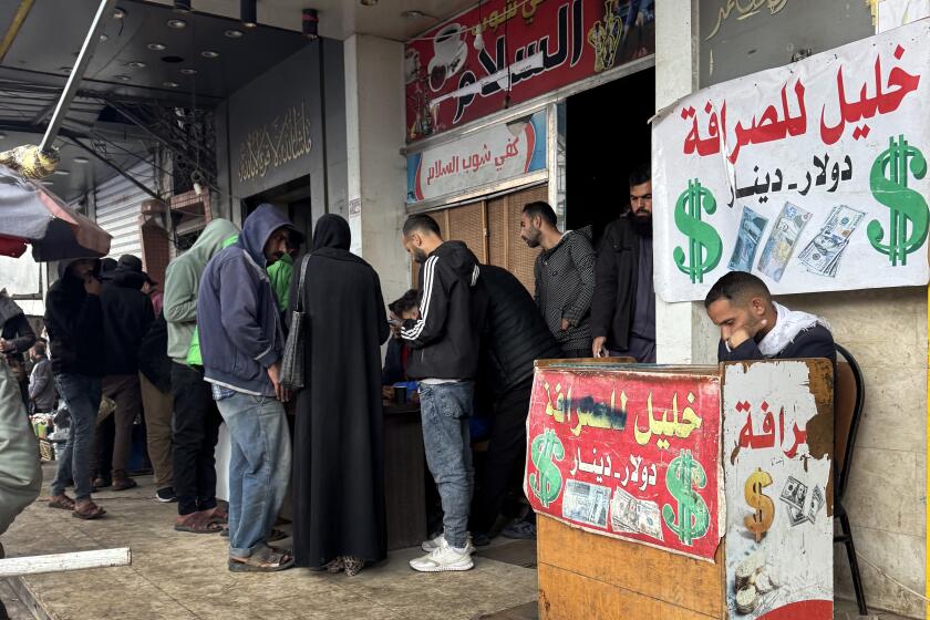 Deir al-Balah, Gaza-Dec. 3, 2024-Inside Actionha cafe shop in Deir al-Balah which has turned to be only for cashiers and those locals withdrawing cash via an app of BOP. Anyone there has to order a hot drink and a WiFi ticket for 5 shekels. = nearly $2 These old Israeli banknotes are not easily accepted by either vendors nor cashiers. A double issue of an old version of banknotes (banknotes of 50/100/200) plus the worn out US dollars. This was also in the city center where many cashiers hve their stands. 3896: "Displaced individuals gather here to inquire about commission rates, exchange currency, or collect cash from international money transfers." This is in the city center of Deir al-Balah.