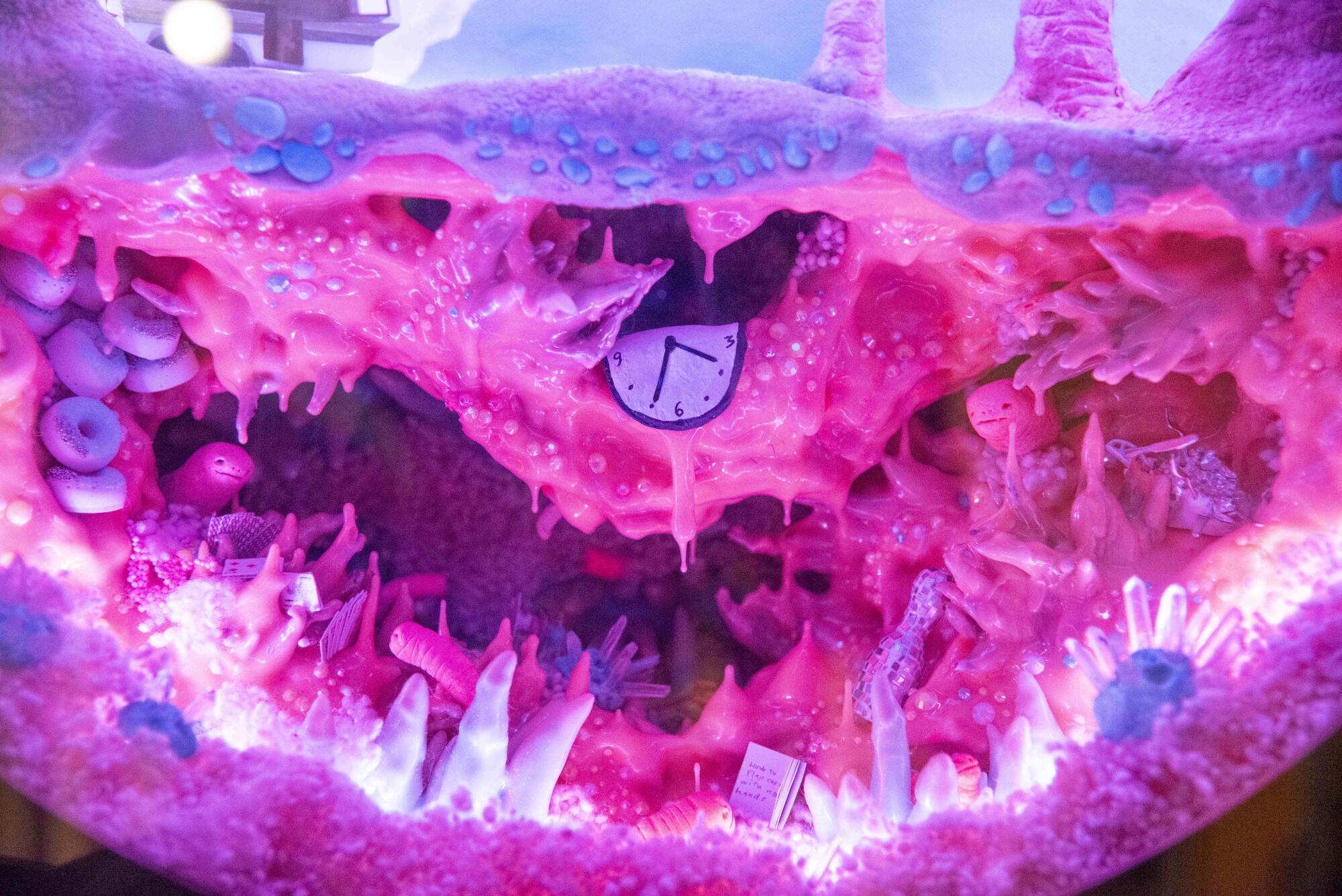 A heavily pink psychedelic Meow Wolf sculpture. 