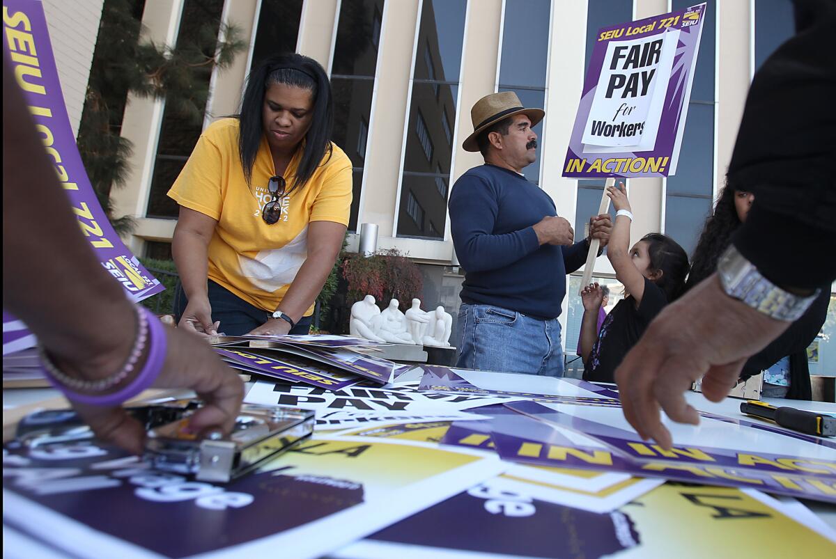 Members of the Service Employees International Union make picket signs at union headquarters downtown.