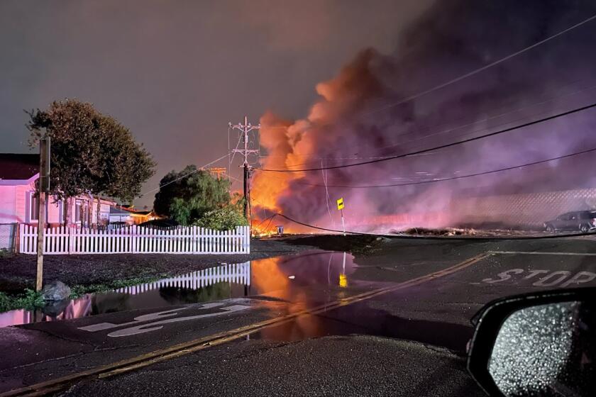 Smoke and flames rise in the air after a plane crashed in the unincorporated Bostonia neighborhood 