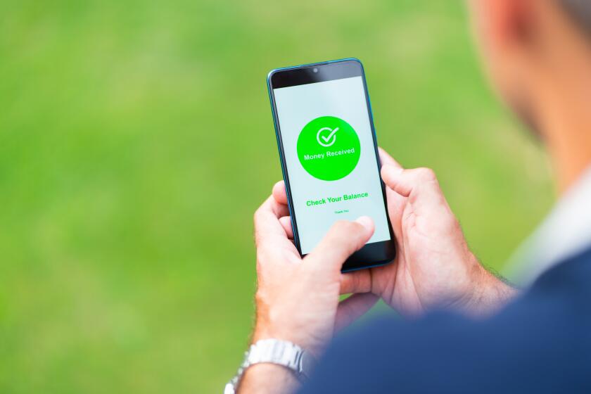 Close-up of a man's hands holding a mobile phone with the application for money transfer. He received a payment.