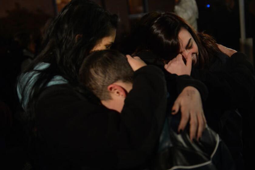 People gather at a prayer vigil at St. Rose Church in Newtown, Conn., on Friday.