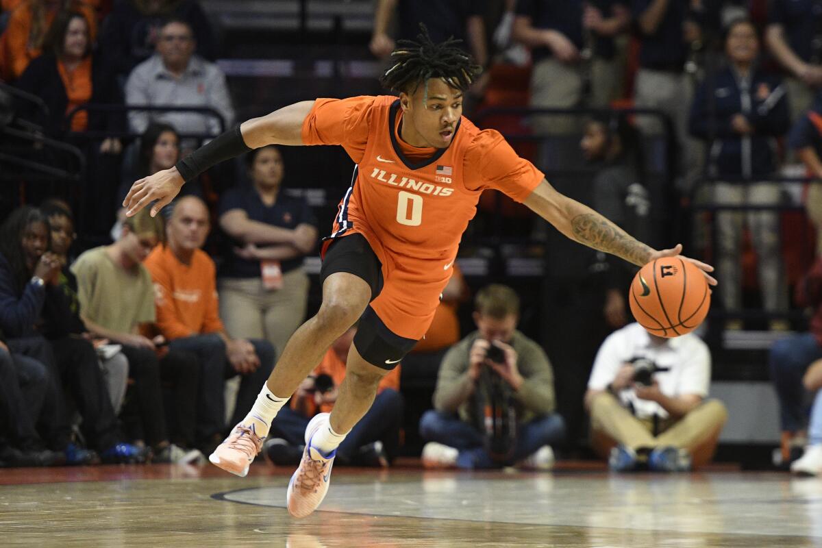 Illinois' Terrence Shannon Jr. reaches for the ball during the first half of an NCAA college basketball game against Monmouth, Monday, Nov. 14, 2022, in Champaign, Ill. (AP Photo/Michael Allio)