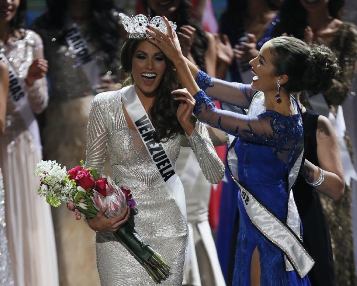 Miss Universe 2012 Olivia Culpo, from the United States, right, crowns her successor, Miss Venezuela Gabriela Isler, during the 2013 Miss Universe pageant in Moscow.